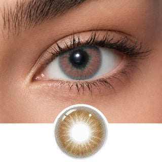 A close-up of a person’s eye wearing EyeCandys Aura Brown Grey contacts, with a detailed lens image below. The design features a golden-brown pattern, clear pupil center, and provides UV protection.
