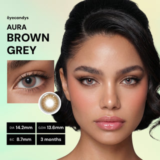 A woman with smooth, medium skin and shiny dark hair wears EyeCandys Aura Brown Grey contacts. Inset shows her eye and the lens design. Specs: DIA 14.2mm, G.DIA 13.6mm, B.C. 8.7mm, for 3-month use by EyeCandys.