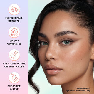 Close-up of a woman wearing EyeCandys Aura Green Grey contacts, giving her eyes a jewel-toned color. Left side displays: "Free shipping on US$75," "30-day guarantee," "Earn candycoins," and "Subscribe & save." Brand: EyeCandys.