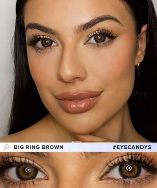 A woman with long dark hair and brown eyes wears makeup and gold hoop earrings, showcasing EyeCandys Pink Label Big Ring Brown lenses—doll-like, eye-enlarging contacts that highlight her lashes and smooth skin. Text: "BIG RING BROWN #EYECANDYS.
