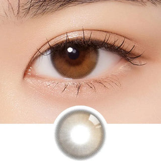 Close-up of a person’s brown eye with long lashes, wearing Olola Daymood 1-Day Brown contact lens by Olola that enhances the iris color. A single myopia prescription lens from the 10pk is displayed below for comparison.