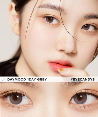 A close-up of natural brown eyes, with a second image below showing the eyes wearing Olola Daymood 1-Day Grey (10pk) lenses. Text reads “Olola Daymood 1-Day Grey” and “#EYECANDYS.”.