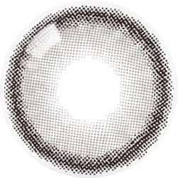A close-up of Olola Dearsome Ash Grey by Olola, a lens with a dark dotted ring pattern and clear center, designed to enhance dark eyes.