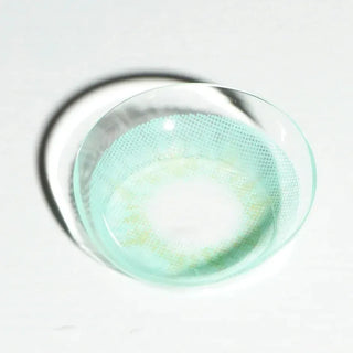 High quality macro shot flatlay of Dewy Aqua Contact lens in a plain white backdrop showing the details of the lens