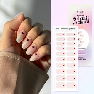 Hand displaying EyeCandys Don’t Play With My Heart Gel Nail Stickers featuring a soft pink base with tiny red hearts. Romantic, minimalist nail design perfect for Valentine’s or date-night looks. Semi-cured gel formula lasts up to 2-3 weeks, cures easily under UV light for a salon-quality finish.