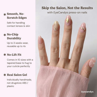 Stylish hand wearing EyeCandys En Rose press on nails featuring soft blush pink manicure, 3D floral design, and gold French tip detailing.