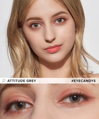 A woman with light blonde hair wears natural makeup and EyeCandys Attitude Glitter Grey colored contacts. The close-up highlights the contacts’ high water content. Text: "ATTITUDE GREY" and "#EYECANDYS".