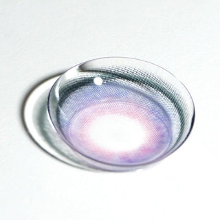 A close-up of EyeCandys Powerglow Bluish Purple contact lens by EyeCandys, featuring a purple and pink gradient on a white surface—ideal for anyone wanting vibrant colored contacts for cosplay or creative makeup looks.