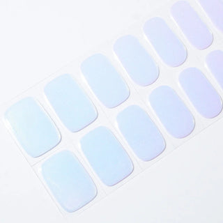Angled image of semi-cured gel nail stickers in the design 'FIji,' featuring a iridescent cool colors ranging from light blue to pinkish purple, perfect for a stylish manicure.