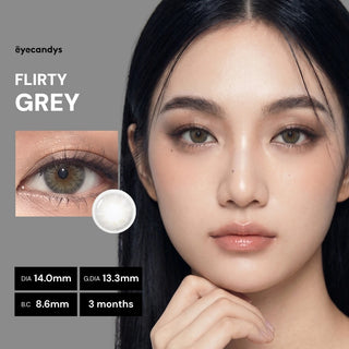 A woman with long black hair models EyeCandys Pink Label Flirty Grey two-tone contacts. A close-up shows the lens and her eye. Specs: DIA 14.0mm, G.DIA 13.3mm, B.C 8.6mm, usable for 3 months.