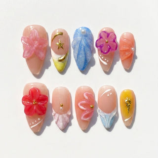 EyeCandys’ Flora Bora Press-On Nails feature ten handmade nails with 3D floral designs, pastel colors, gold accents, beads, and abstract patterns for a salon-quality manicure at home.