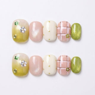 EyeCandys’ Garden Variety Press-On Nails includes 10 reusable handmade nails in green, pink, and white. Pastel and metallic designs feature florals, polka dots, plaid, and shimmer for a delicate spring-inspired manicure.