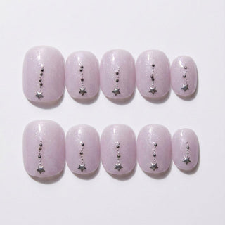 EyeCandys Gemini Press-On Nails: Set of 10 handmade, light lavender nails with a subtle shimmer, each adorned with a vertical line of silver beads and a silver star charm at the tip for a salon gel manicure look.