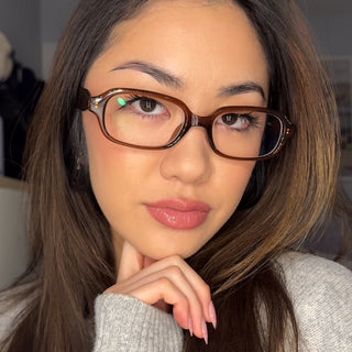 Model styling EyeCandys Side Eye blue light blocking reading glasses, sharp rectangular silhouette, polished everyday look