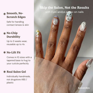 Stylish hand wearing Eyecandys Headliner press on nails featuring color block stripes, red star details, and shimmering rhinestone clusters.