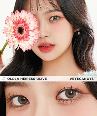 A woman with wavy dark hair holds a pink and white daisy over one eye, wearing Olola Heiress Olive color contacts for dark eyes; a close-up of her eyes appears below. Text: "OLOLA HEIRESS OLIVE #EYECANDYS".