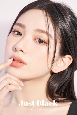 A close-up of a model demonstrating a natural makeup look with Ann365 JUST Black (Toric for Astigmatism) (1 PAIR) circle colour contacts, highlighting how well the contact lenses blend with her dark eyes.