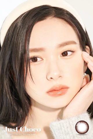 A close-up of a model demonstrating a natural makeup look with Ann365 JUST Choco (Toric for Astigmatism) (1 PAIR) circle colour contacts, highlighting how well the contact lenses blend with her dark eyes.
