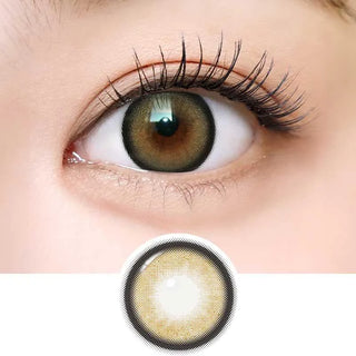 A close-up of a brown eye wearing i-Sha Dekame Love Me Cashewnut Brown contacts; below, a zoomed-in view shows the lens’s limbal ring design with a light center and dark outer rim. Brand: i-Sha.