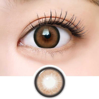 A close-up of an eye with long lashes wearing i-Sha Dekame Love Me Toffeenut Brown Colored Contacts. Below, the lens shows its rich natural brown color and pattern, inspired by Japanese contact lenses for a subtle look.