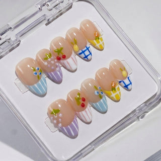 The EyeCandys Macedonia Press-On Nails set features pastel stripes, plaid patterns, and cute fruit art like cherries and lemons, all arranged in a clear case for a salon-quality gel manicure at home.