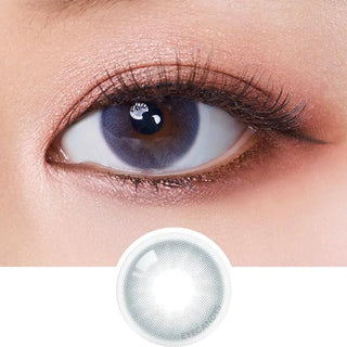 A close-up of an eye wearing Olola Mellows Mystic Grey by Olola, with the lens shown below for detail. The natural makeup highlights these stylish color contact lenses, ideal for myopia prescription needs.