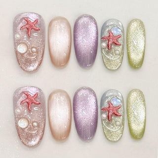 Oval press on nails EyeCandys Mermaid on Duty with multicolor cat eye bases, holographic glitter finish, sculpted red starfish, and moonstone accents.
