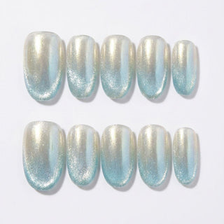 EyeCandys Moon Glass Press-On Nails: Set of 10 handmade nails in two rows, showcasing a pearlescent shimmer and gradient from pale gold to light blue—perfect for achieving a salon-quality gel manicure at home.