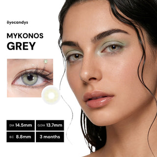 Model wearing EyeCandys Pink Label Mykonos Grey colored contact lenses with soft warm-grey tones and defined outer ring for a natural bold look