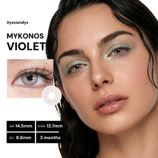 Model wearing EyeCandys Pink Label Mykonos Violet colored contact lenses with soft beige base and striking violet ring for a bold, hazy eye look