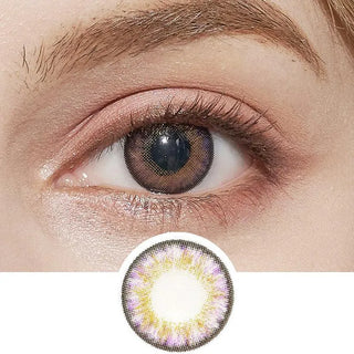 A close-up shows an eye wearing NEO Vision Cosmo Violet circle lenses by NEO Vision, featuring a brown center and an outer ring with yellow and purple accents. The violet lenses are also displayed below the eye for detail.
