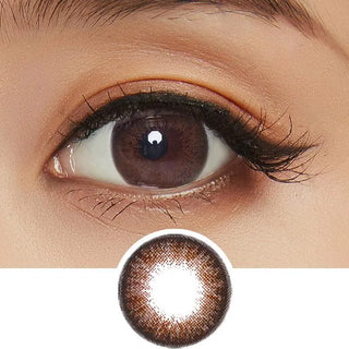 A close-up of a brown eye with long lashes wearing NEO Vision Monthly Extra Dali Brown circle lenses. Below the eye is an enlarged image showing the lens design by NEO Vision.