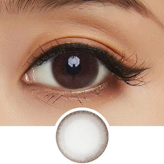 A close-up of a brown eye with long lashes and natural makeup, featuring NEO Vision Monet Brown (Custom Toric for Astigmatism) by NEO Vision—ideal for a natural look with a defined dark outer ring.