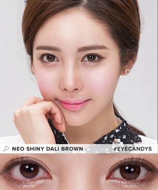 A woman with smooth skin and glossy pink lips gazes at the camera. Below, a close-up shows her eyes before and after wearing NEO Vision Weekly Shiny Dali Brown (12pk) contact lenses, revealing their subtle enhancement.