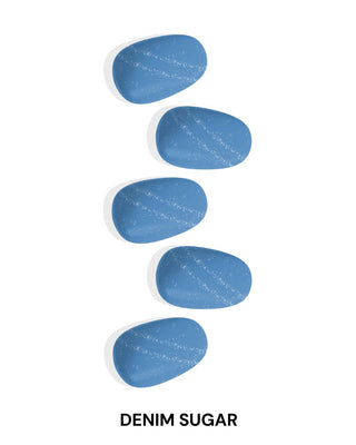  Close-up of EyeCandys Denim Sugar Gel Nail Stickers in a glittery blue design. Effortless spring nails with a 7-free, allergy-friendly formula that lasts 2-3 weeks. Cures in sunlight, no UV lamp required, for a chic, sparkling nail look.