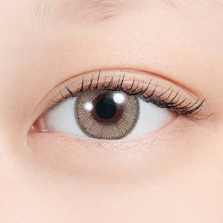 Close-up of eye wearing EyeCandys N's Collection Tempura Beige (10pk) prescription colored contact lens, warm beige brown iris with soft two-tone gradient and natural finish, Korean daily disposable contact lens for subtle everyday eye enhancement