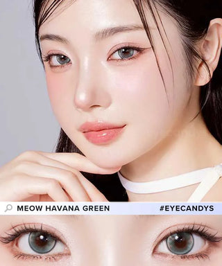 A fair-skinned woman with glossy pink makeup wears Olola Meow Vivid Havana Green contacts by Olola. A close-up shows the vibrant green lenses in her eyes. Text: "Meow Havana Green" and "#EyeCandys".