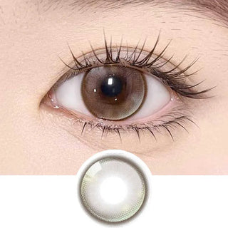 A close-up of an eye wearing Olola Meow Vivid Savannah Brown contacts by Olola, with long lashes and an alert gaze. Below is a detailed image of the prescription color contacts.