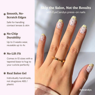 Hand wearing reusable Sunday Dots press on nails with pastel French tips and polka dot accents for a fresh and effortless nail aesthetic.