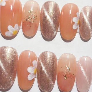 Peachy Keen press on nails by EyeCandys featuring burnt sienna jelly base with hand painted white daisy flowers, gold foil accents, and warm summer tones.