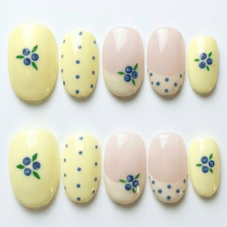 Blueberry Tart press on nails by EyeCandys featuring cream and blush base with hand painted blueberry clusters, green leaves, and blue polka dot accents.