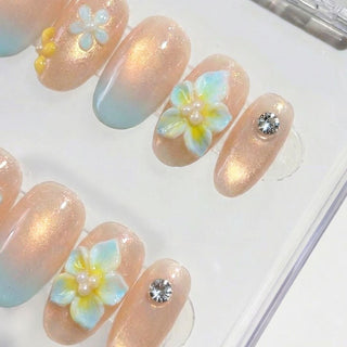 Lei’d Back press on nails by EyeCandys featuring nude to gold shimmer to baby blue ombre with 3D plumeria flowers, pearl centers, and tropical floral accents.