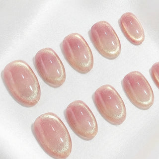 Close-up of EyeCandys Grapefruit Soda press on nails on a white background featuring semi-sheer cat-eye pink gradient with soft grapefruit tones, subtle shimmer, and translucent finish.