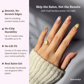 Hand wearing EyeCandys Star Script press on nails with sunset gradient tones and gold star-inspired detailing.