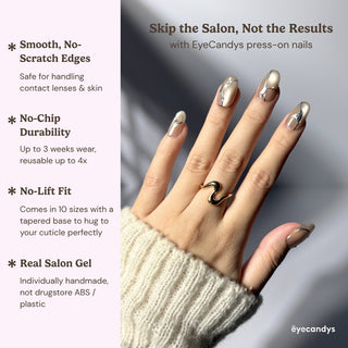 Hand wearing EyeCandys In the Lines press on nails with soft pearly white finish, thin silver vein design, and subtle gems.