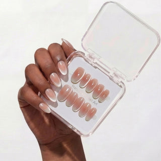 Hand featuring EyeCandys Cloud Nine press on nails with clean milky white gradient and subtle celestial cat-eye glow.