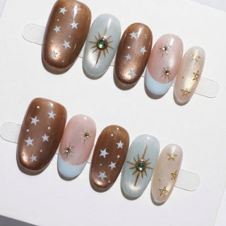 Space Bar press on nails by EyeCandys featuring copper bronze cat eye, blush tones, baby blue French tips, and celestial starburst design luxury reusable press on nails.