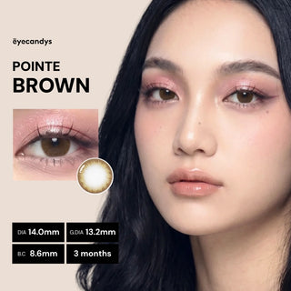 A woman with long dark hair wears pink eye makeup and EyeCandys Pink Label Pointe Brown contact lenses. A close-up shows the natural lens (DIA 14.0mm, G.DIA 13.2mm, B.C 8.6mm) for 3 months use. Text reads “Pointe Brown.”.