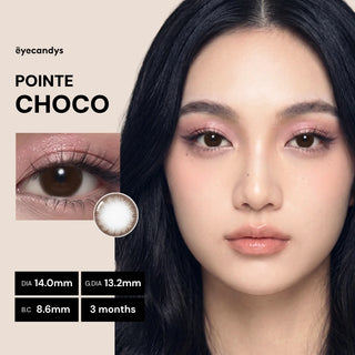 A woman with long black hair wears EyeCandys Pink Label Pointe Choco contact lenses. Text displays lens details: DIA 14.0mm, G.DIA 13.2mm, B.C 8.6mm, and a usage period of 3 months.