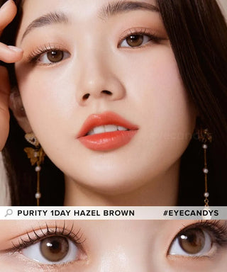 A close-up of a woman with flawless skin, coral lipstick, and wearing Olola Purity Shine 1-Day Hazel Brown contact lenses. A zoomed-in view of her eyes highlights these daily disposables. Text: "Olola Purity Shine 1-Day Hazel Brown.